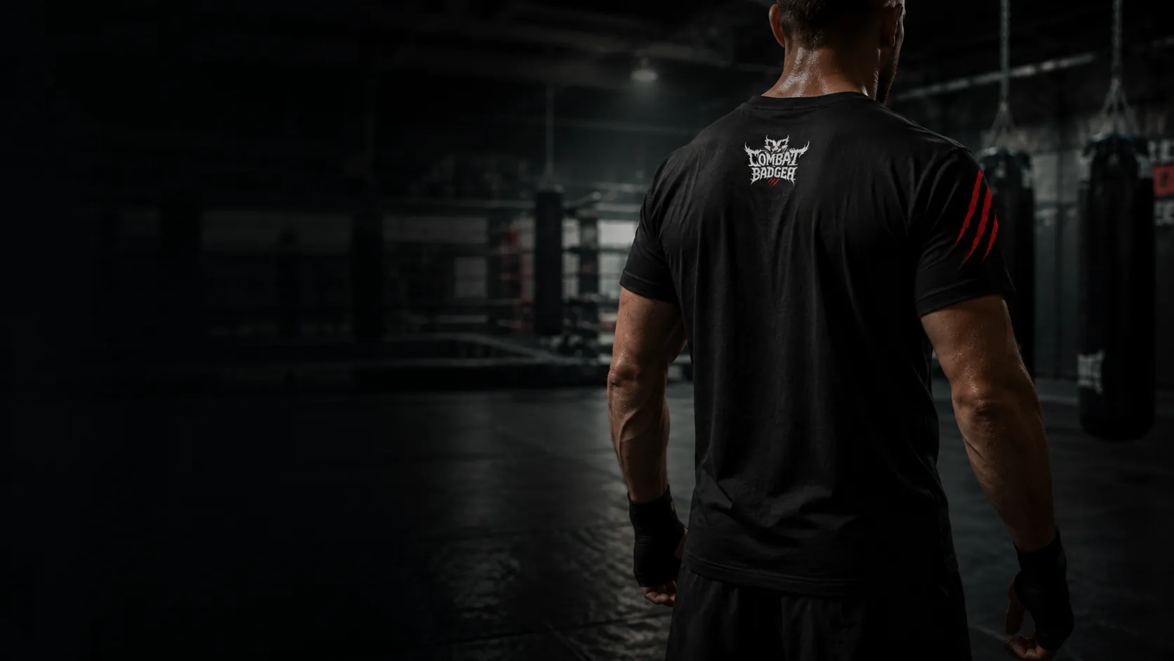 Athlete wearing the Combat Badger tee in a dark gym